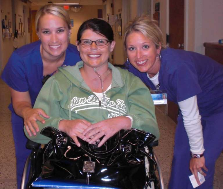 Nurse holding the hand of a palliative care client