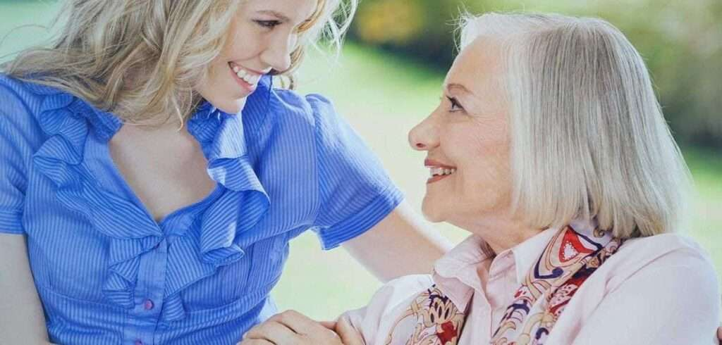 Caregiver assisting an elderly client during a home visit