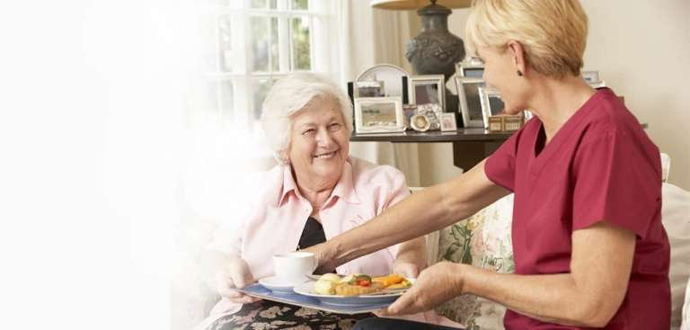 Caregiver preparing a nutritious meal for a senior client